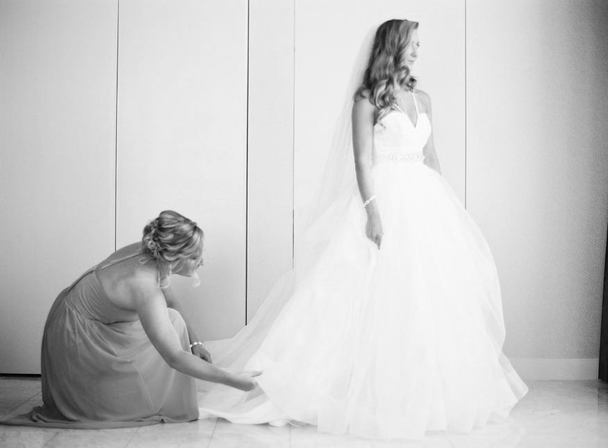 Bride putting on her Hayley Paige wedding dress before her Crystal Tea Room wedding.